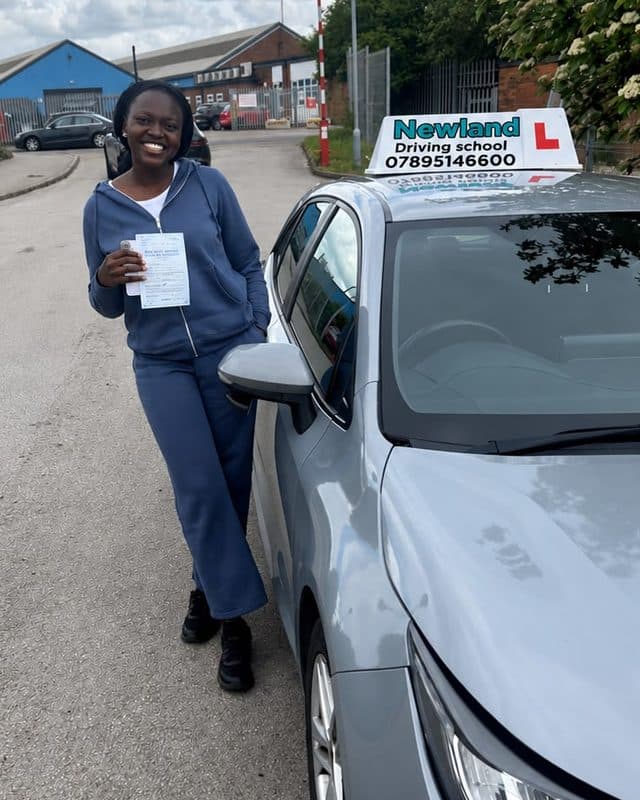 Pupil in a blue tracksuit with her pass certificate
